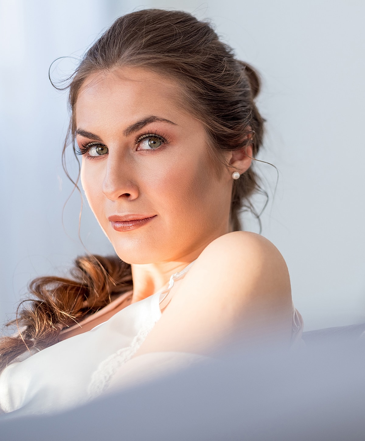 Woman with long hair and stylish makeup.