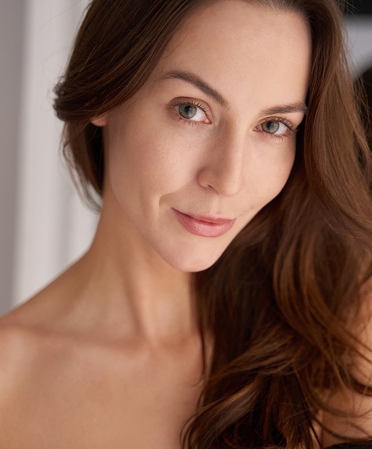 Woman with long hair and natural makeup.