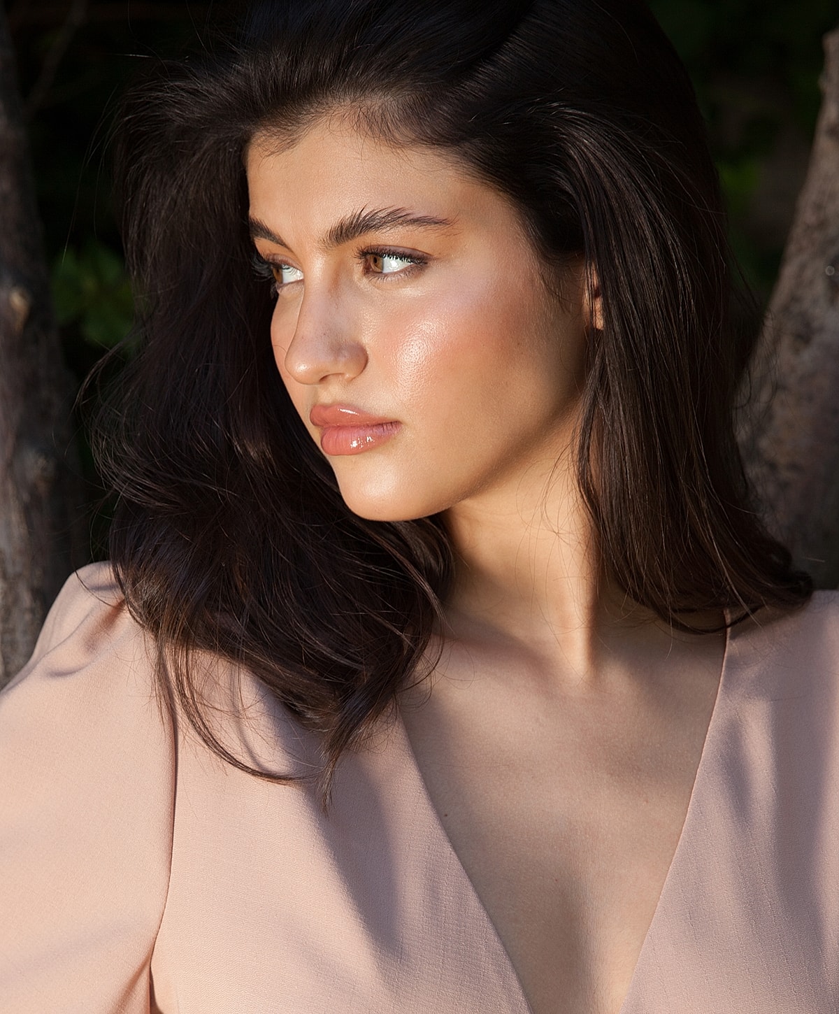 Young woman with long hair in soft light.