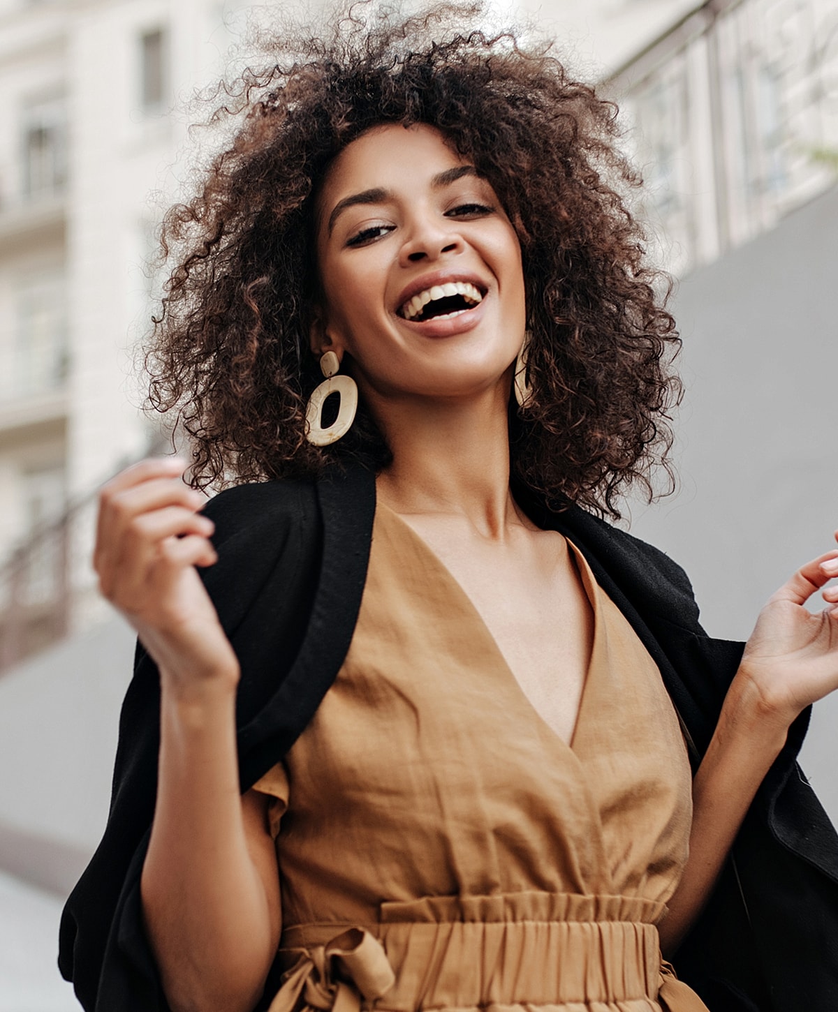 Smiling woman in a stylish outfit outdoors.